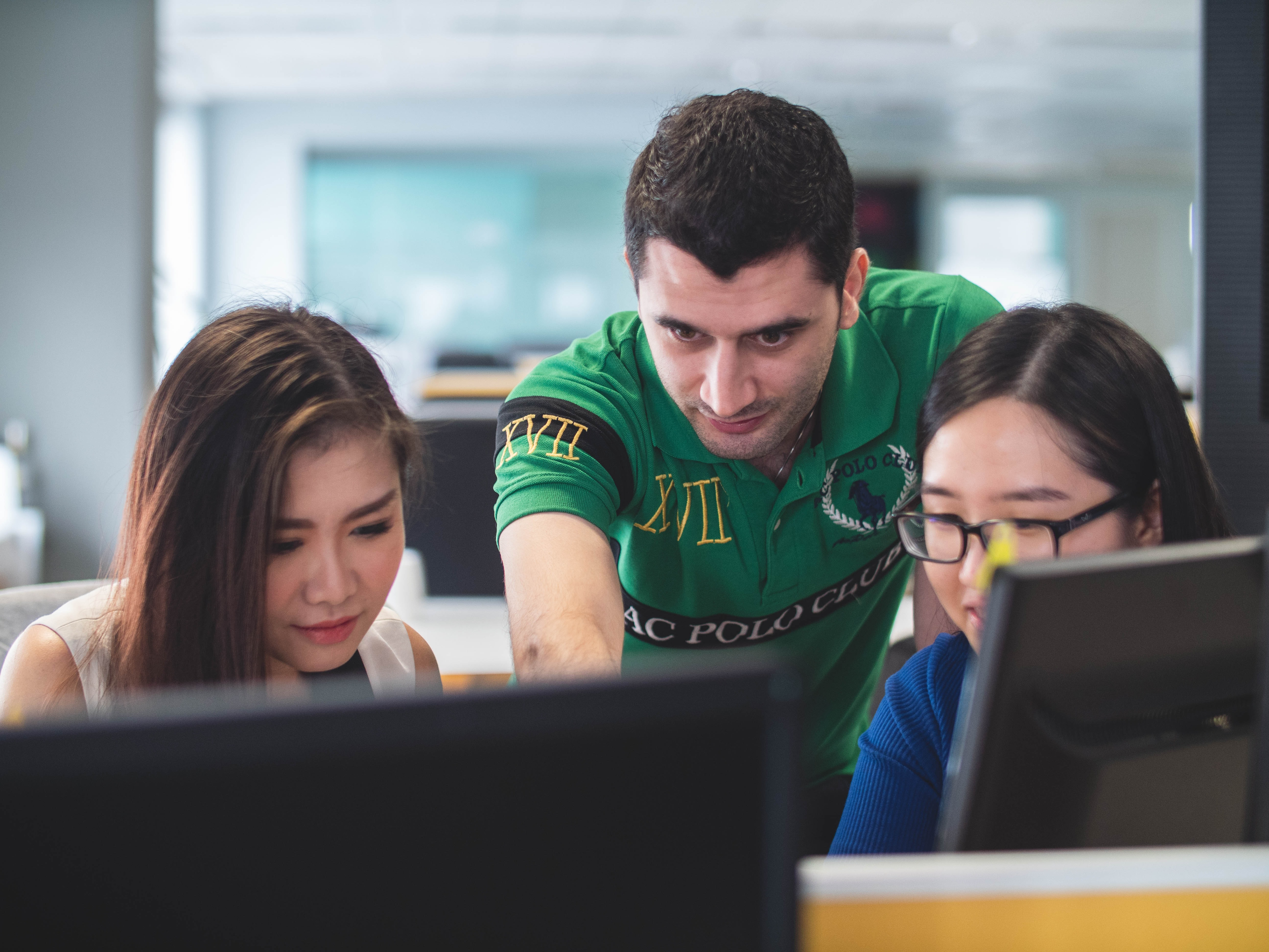 Three people looking at computer screens